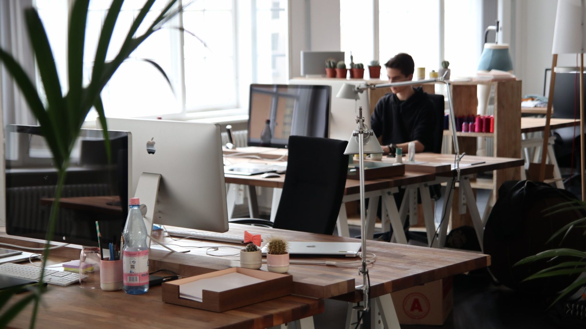 Modern office setting with multiple workstations, highlighting the use of CLDigital's operational resilience software in a business environment.